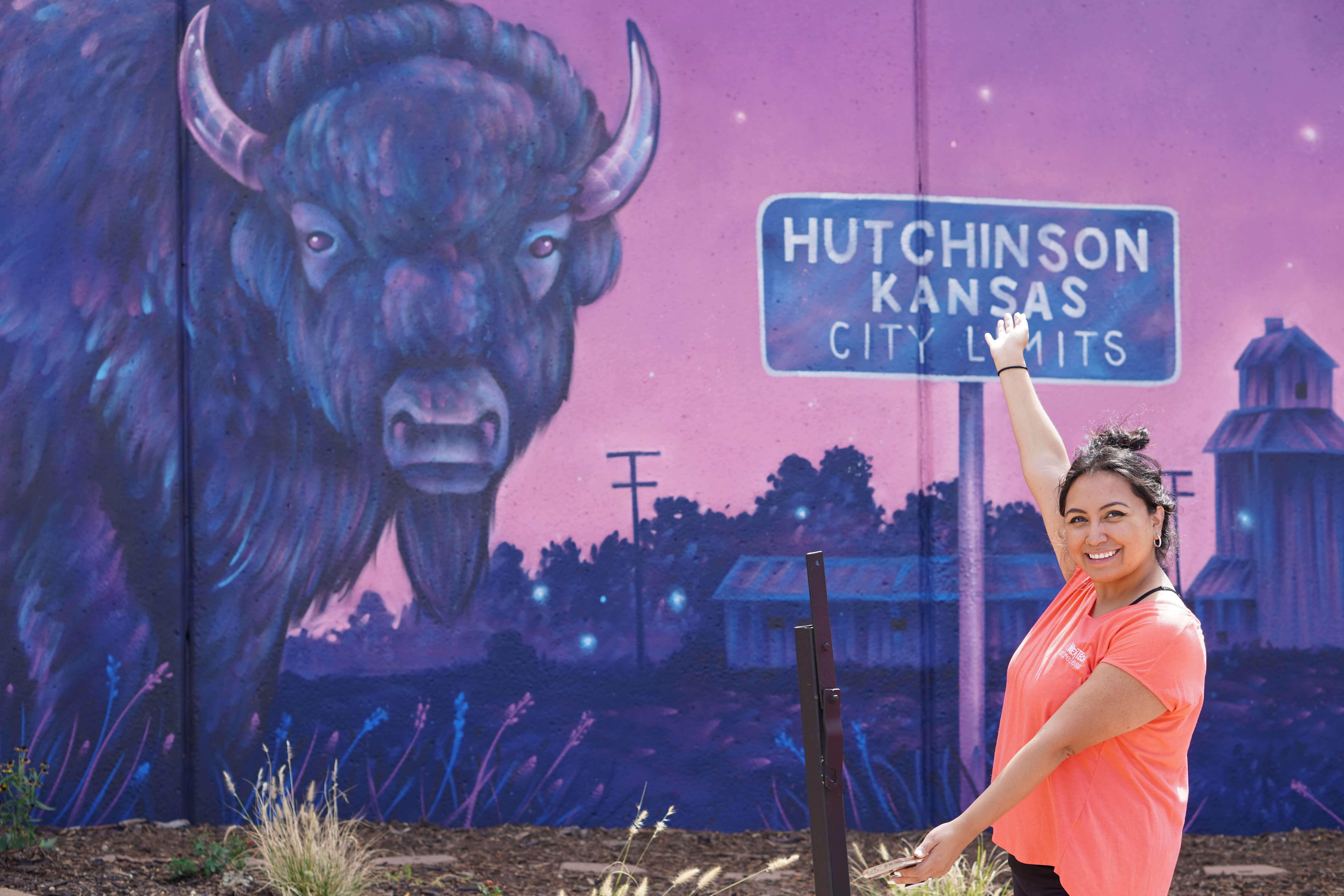 Whitney posing in front of mural